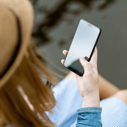 image of a lady holding a mobile phone